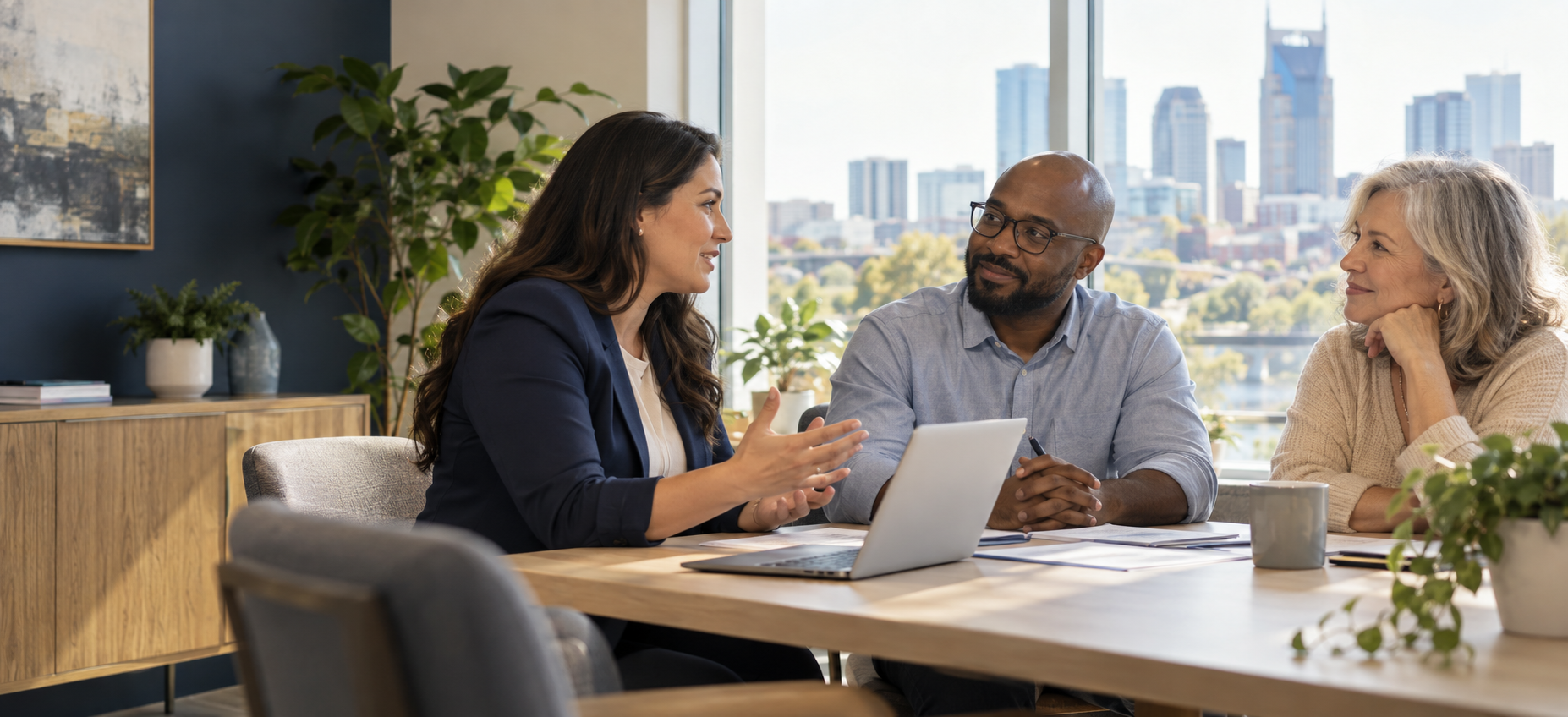 A diverse group of coworkers discussing employee benefits around a conference table.